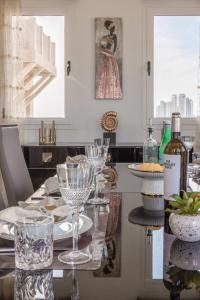 a kitchen with a table with wine glasses on it at Frank Porter - Al Badia 2 in Dubai