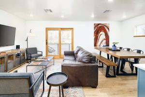 a living room with a couch and a table at Near Downtown Stylish 2BR With Amazing Patio - #2 in Moab