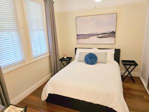 a bedroom with a bed with a blue ball on it at New: Araluen, Heart of Bowral in Bowral