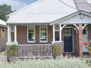 a small brick house with a black door at New: Araluen, Heart of Bowral in Bowral