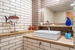 a bathroom with a white sink and a mirror at Luxury Designer Beach Front Two Bedroom Apartment in Salou +23 photos
