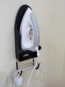 a telephone hanging on a wall with a chain at Roomstay Villa Tok Wan in Kuantan