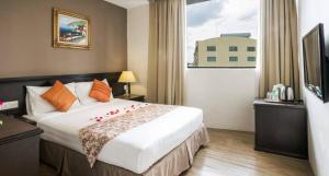Postel nebo postele na pokoji v ubytování PJ De Inn Hotel