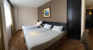 Postel nebo postele na pokoji v ubytování PJ De Inn Hotel