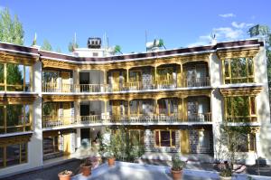 an apartment building with a lot of windows at Hotel Lhalingkha in Leh