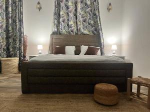 a bedroom with a large bed with a large headboard at Trou aux Biches Serenity in Pointe aux Biches +18 photos