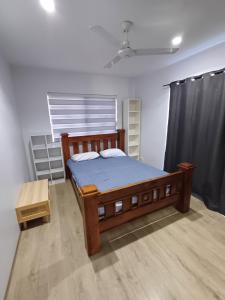 a bedroom with a wooden bed in a room at Modern Hillside Apartments in Kelmscott