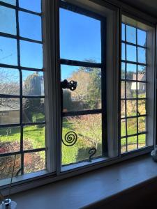 a window with a view of a yard at Reynolds House in Faringdon