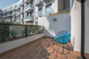 a balcony with two chairs and a table at izzzilife Mint in Dubai