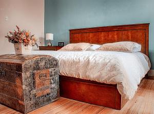 a bedroom with a large bed with a wooden headboard at Casa 1881 in Riobamba