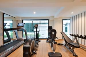 a gym with treadmills and elliptical machines at Villa De Pranakorn in Bangkok