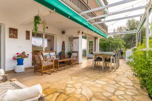 a conservatory with a table and chairs at Luxury Designer Beach Front Two Bedroom Apartment in Salou