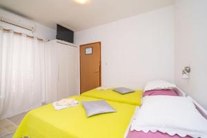 two beds sitting next to each other in a room at Apartments Aurelia in Dubrovnik