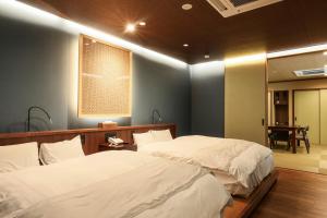 Кровать или кровати в номере Beautiful Japanese Garden Kagetsu