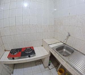 a small kitchen with a stove and a sink at Omah Tegalrejo Family Only in Jetis +14 photos