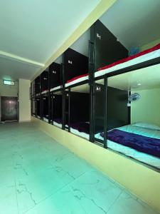 a room with several bunk beds in a building at The Darsya Varanasi in Varanasi