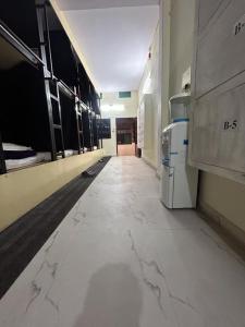 an empty room with a hallway with white marble floors at The Darsya Varanasi in Varanasi
