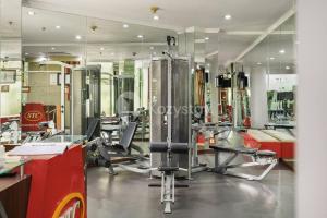 a gym with chairs and mirrors in a room at Avante by Kozystay - 3BR - Spacious - Semanggi in Jakarta