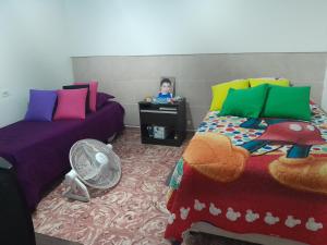 a room with two beds and a little girl in a mirror at El rosal ,descanso para viajeros in Junín