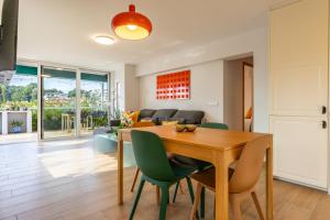 a dining room and living room with a table and chairs at Luxury Designer Beach Front Two Bedroom Apartment in Salou