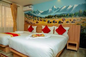 a bedroom with two beds with a painting on the wall at Hotel Kedarnath in Kathmandu