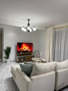 a living room with a couch and a fireplace at Kilimani in Nairobi