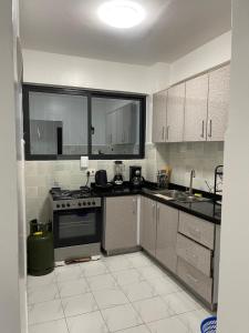 a kitchen with a stove and a sink in it at Kilimani in Nairobi