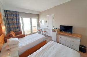Postel nebo postele na pokoji v ubytování Beau Site Hotel