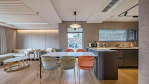 a kitchen and dining room with a table and chairs at Jeju Family Garden Village in Jeju