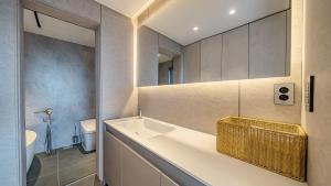 a bathroom with a sink and a toilet at Jeju Family Garden Village in Jeju +18 photos