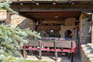 a group of benches in front of a brick oven at Дренковите Къщи Drenkovi Houses in Kovačevica