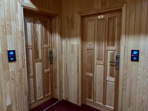 a row of wooden doors in a building at Lahza Hills Resort in Çaykara