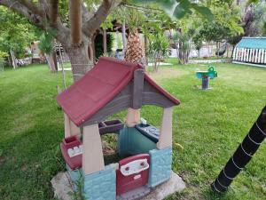 a toy playground with a giraffe in a park at Nikos Apartments in Ormos Panagias