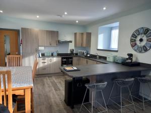 a kitchen with a counter and a table in it at 19a Francis Street in Stornoway