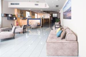 a lobby with a couch and chairs in a building at Blu Hotel - Sure Hotel Collection by Best Western in Collegno