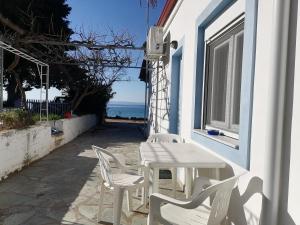 a table and chairs on the side of a house at Porto Almira Studio in Nikiti