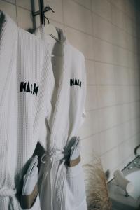 a group of white shirts hanging on a rack at Kalk Hotel in Visby +62 photos