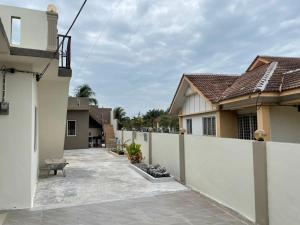 a white fence in front of a house at Sepang Putra Bagan Lalang Semi D House in Sungai Pelik