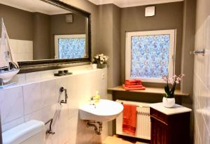 a bathroom with a sink and a mirror at Sonnenhof Bad Schandau in Bad Schandau +41 photos
