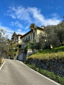 a house sitting on the side of a road at Le Palme House Rifugio Romantico & late check-out in Perledo