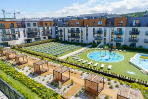 an apartment complex with a large courtyard with a pool at Bel Mare 107 F in Międzyzdroje