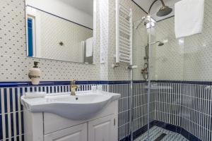 a bathroom with a sink and a shower at Karmelicka Stylish Apartments in Cracow by Renters in Krakow