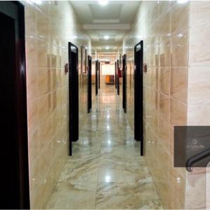 a hallway in a building with wooden walls and ailed floor at MCLORRETS SUITES in Enugu