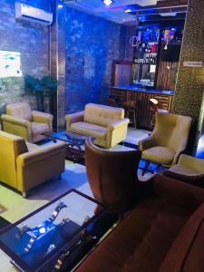 a living room with couches and a bar at MCLORRETS SUITES in Enugu