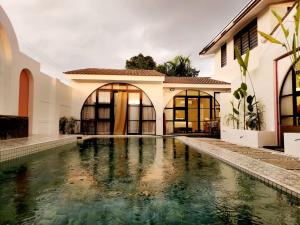 a swimming pool in front of a house at Ipoh Young Villa - Hotel Inspired in Ipoh