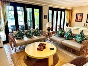 a living room with couches and a table at Eden Island Luxury Accommodation in Eden Island