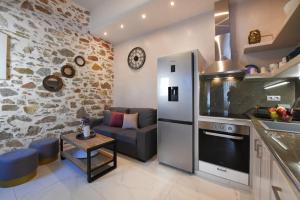 a kitchen with a couch and a table in a room at Alesio's house in Ermoupoli