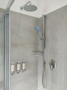 a bathroom with a shower with a glass door at Massimi City Garden in Rome