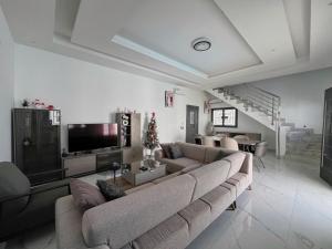 a living room with a large couch and a television at Lovers Villa Somone in Somone