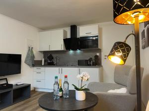 a living room with a table and a kitchen at Top Apartment Zentrum Bad Urach in Bad Urach